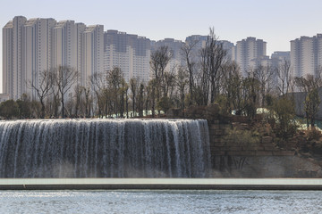 Kunming, China - March 4, 2016: Kunming Waterfall park featuring a 400 meter wide manmade...