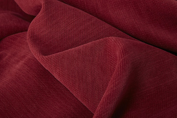 A full page close up of a rich red upholstery fabric texture