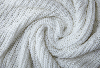 A full page close up of a swirl of white knitted material texture