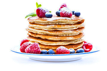 Pile of pancakes with blueberries and raspberries 