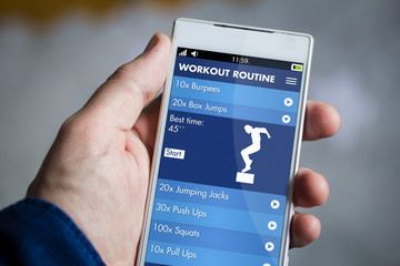 holding fitness app smartphone