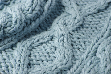 A full page close up of pastel blue knitted sweater fabric texture