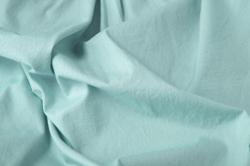 A full page close up of pastel turquoise shirt fabric texture