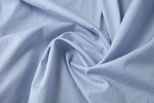 A full page close up of pastel blue shirt fabric texture