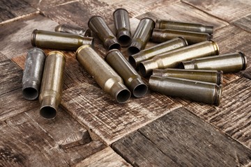 Bullets shells on wooden background. Stock image macro.