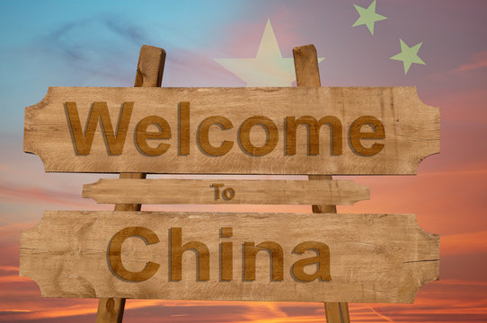 Welcome to China sing on wood background with blending national flag