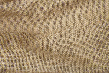A full page close up of natural colored hessian fabric texture