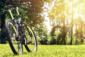 Fototapeta na wymiar Summer landscape with sport bike on green field. Health concept 