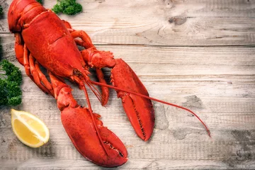 Zelfklevend Fotobehang Steamed lobster with lemon on wooden  background © Grecaud Paul