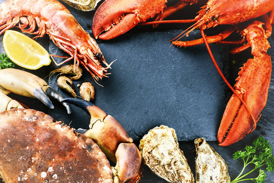 Food frame with crustacean for dinner. Lobster, crab, jumbo shri