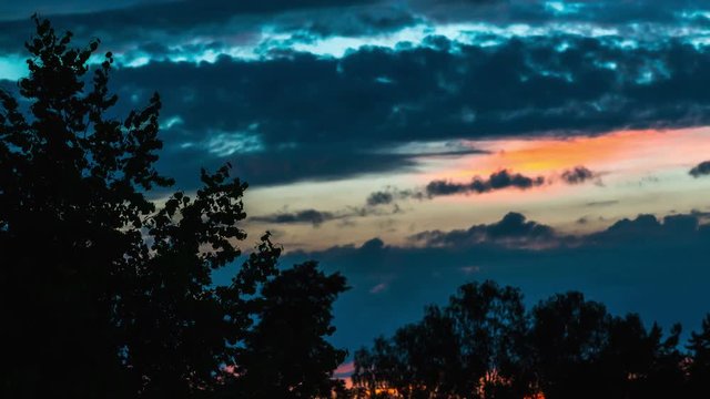 Summer sunset landscape with clouds running across the sky, time-lapse.