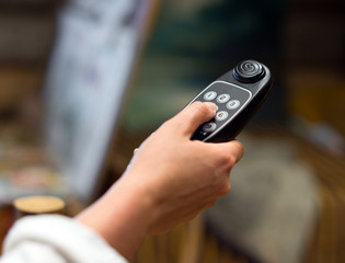 Woman holding an audio guide device.