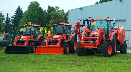 Agricultural machinery standing near hangar.