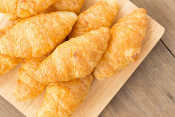 fresh croissants on wooden table