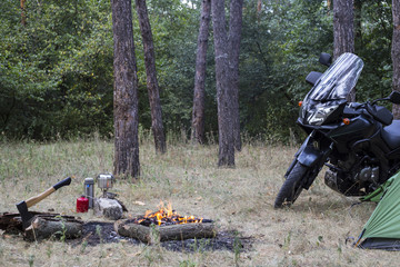 Camping in the woods bike standing next to the tent.