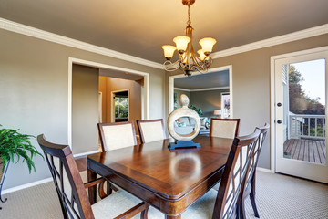 Open floor plan dining area with exit to walkout wooden deck