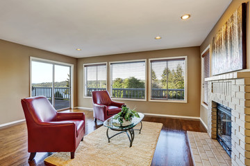Cozy living room interior with fireplace and two red armchairs