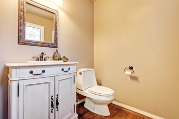 Traditional bathroom interior with vintage vanity and mirror.