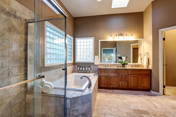 Fototapeta na wymiar Luxury bathroom interior with vanity with granite counter top, large mirror and tile floor.