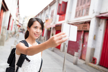 Woman taking selfie by digital camera