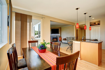 Dining area with wooden table set. Open floor plan.
