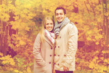 smiling couple hugging in autumn park