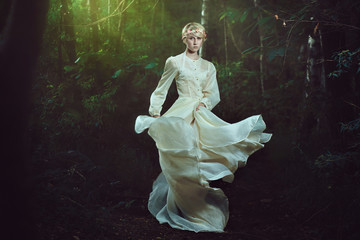 Elfin woman dancing in fairy forest