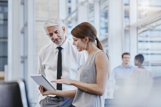 Businessman and businesswoman with digital tablet