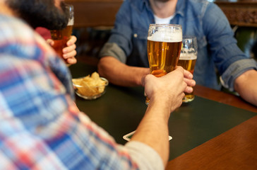 happy male friends drinking beer at bar or pub