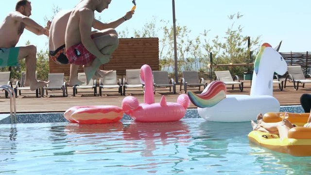 Guy splashed females while sunbathing when jumped in pool. 20s. Super 1080p Slow Motion 240fps.