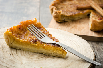 Homemade pumpkin pie on wooden background

