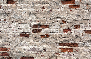 Weathered brick wall texture covered with cement.