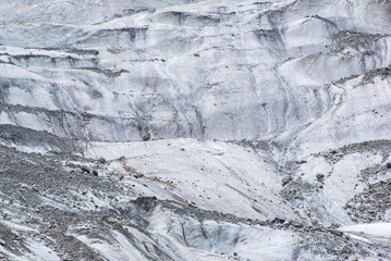 Ice of glacier surface, closeup. Glacial ice nature background. Glacier Chalaadi, the Caucasus. Near Mestia town, Svaneti, Georgia