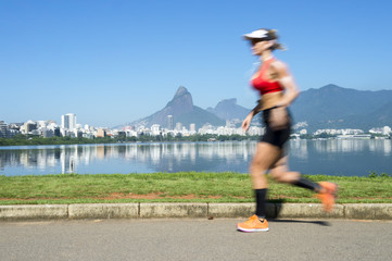 Athletic Brazilian woman jogging at Lagoa Rodrigo de Freitas lagoon, Rio de Janeiro, Brazil