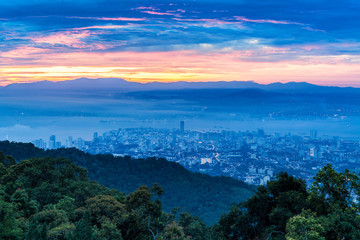 Metropolitan cityscape view from top of the hill or mountain during sunrise sunset