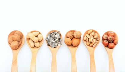 Various nuts in wooden spoons