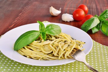 Italian pasta spaghetti with pesto sauce and basil leaf. Spaghetti al pesto.