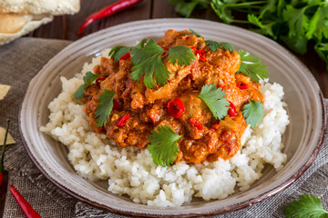 Chicken curry with rice and cilantro.