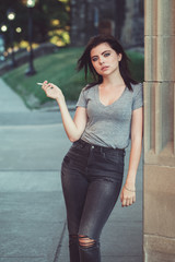 Portrait of white Caucasian beautiful young brunette woman teenager in jeans and t-shirt outside in...
