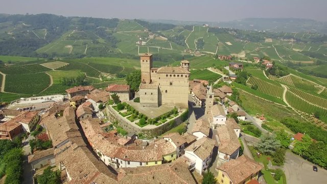 Aerial: flight over beautiful Italian town Serralunga d'Alba and vineyards surrounding it.
