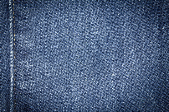 Denim jeans texture or denim jeans background with seam. Old grunge vintage denim jeans. Stitched texture denim jeans background of jeans fashion design.