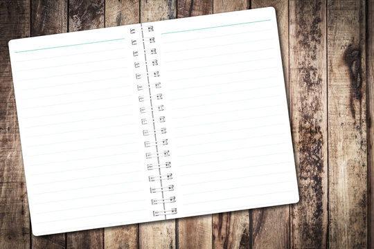 Open notebook paper with line on wood background for design with copy space for text or image.