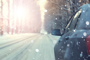 Naklejka premium car on road trees winter sunset