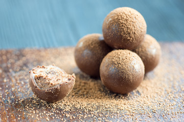 Chocolate Balls with cocao powder on wooden background