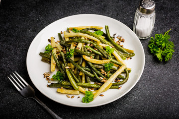 Fried green beans with sunflower seeds and parsley