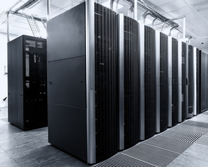 room with rows of modern supercomputers in data center