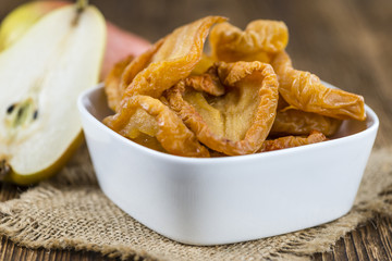 Wooden table with dried Pears (selective focus)