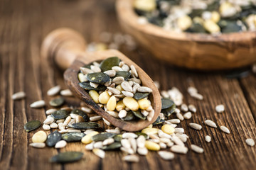 Mixed Seeds on wooden background (selective focus)