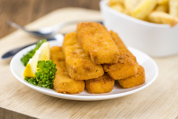 Fisch Sticks (close-up shot) on an old wooden table