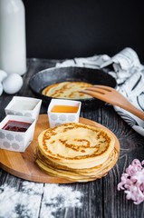 Delicious pancakes with jam on a wooden table